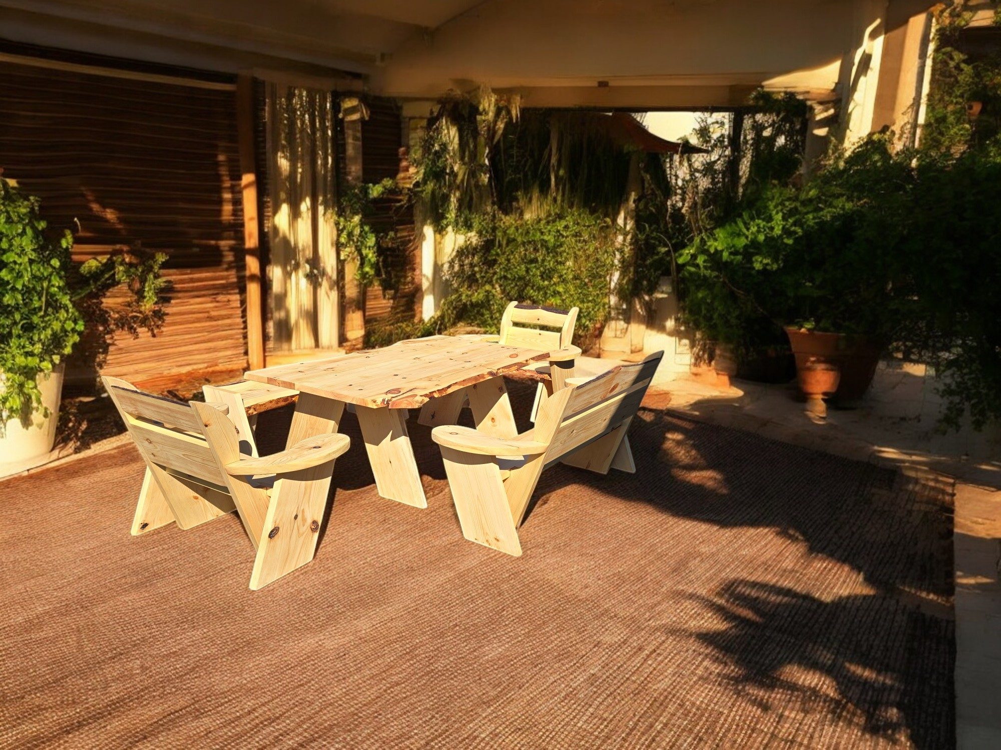 Rustic wooden table and benches on a patio surrounded by greenery.